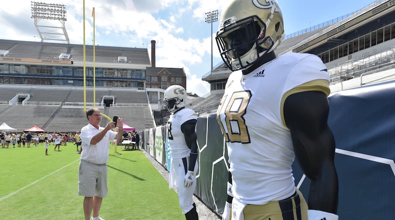 August 11, 2018 Atlanta - John Southard, son of Yellow Jackets legend Jimmy Southard (a three-year starter quarterback for coach Bobby Dodd in the late 40s), takes a picture of new Georgia Tech football uniforms during an annual Georgia Tech Football Fan Day at Bobby Dodd Stadium on Saturday, August 11, 2018. HYOSUB SHIN / HSHIN@AJC.COM