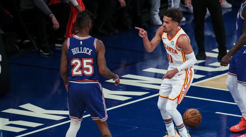 Atlanta Hawks guard Trae Young (11) points to New York Knicks forward Reggie Bullock (25) after scoring in the first quarter of Game 5 of an NBA basketball first-round playoff series Wednesday, June 2, 2021, in New York. (Wendell Cruz/Pool Photo via AP)