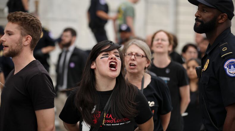 Protesters shout, sing and chant after being arrested by U.S. Capitol Police for demonstrating against the confirmation of Supreme Court nominee Judge Brett Kavanaugh on the center steps of the East Front of the U.S. Capitol on Oct. 06, 2018 in Washington, DC. (Photo by Chip Somodevilla/Getty Images)