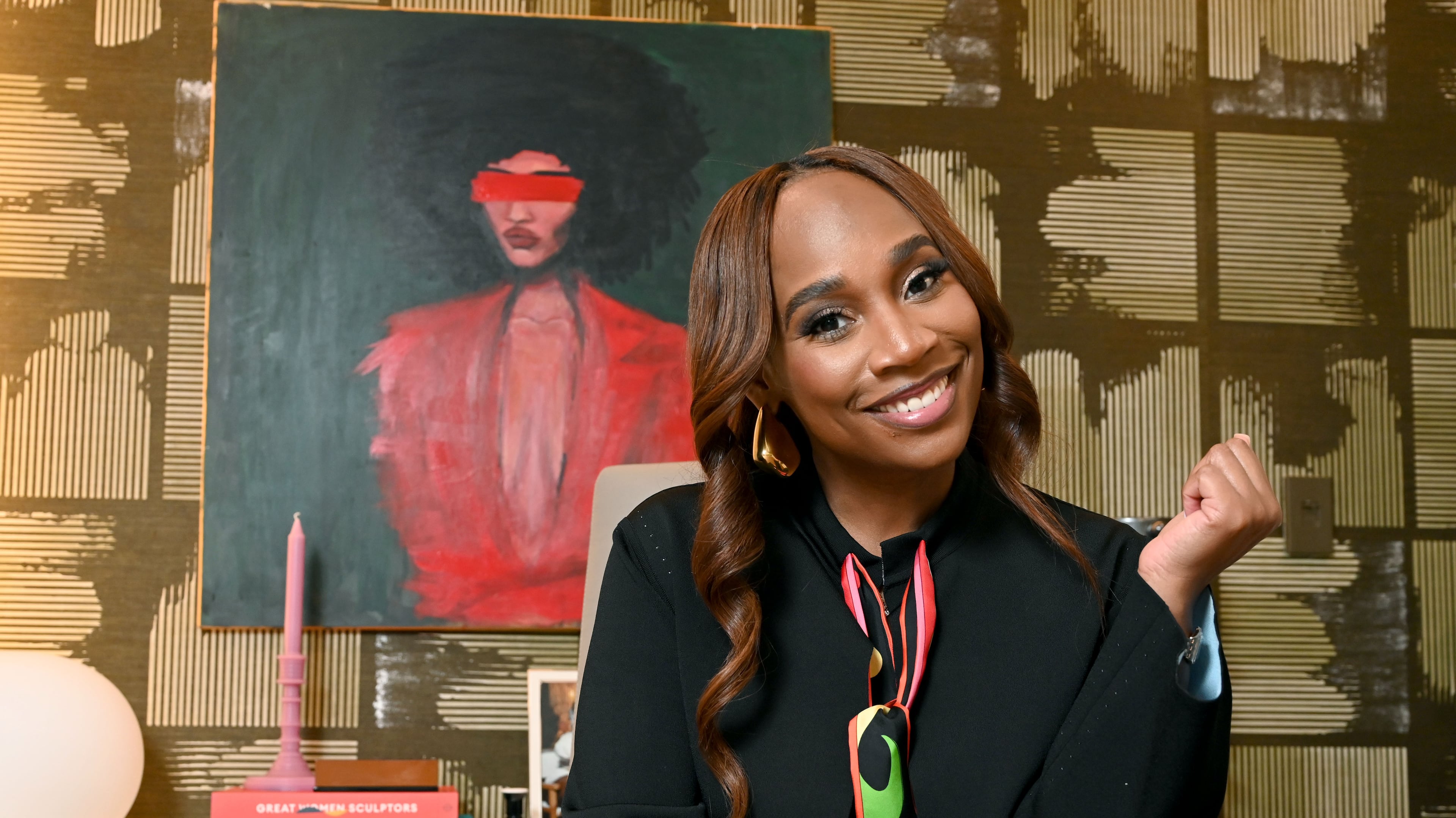Ebonie Ward sits inside her new creative space 550 RMG, a 10,000-square-foot multiuse home in Atlanta for her projects. (Hyosub Shin/AJC)