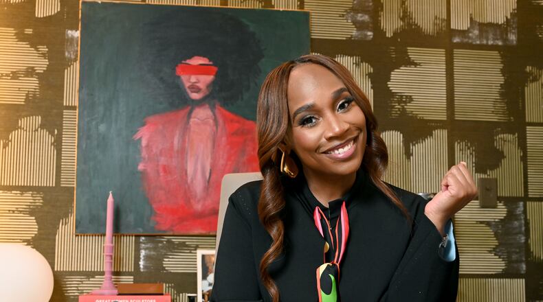 Ebonie Ward sits inside her new creative space 550 RMG, a 10,000-square-foot multiuse home in Atlanta for her projects. (Hyosub Shin/AJC)