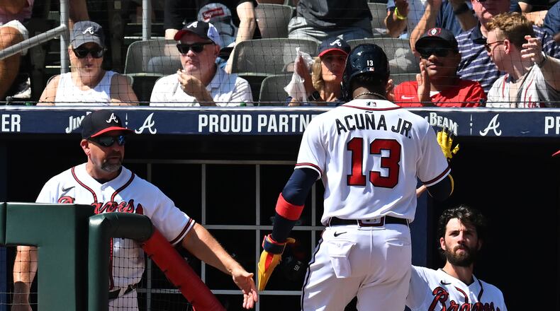 Braves right fielder Ronald Acuña (13) celebrates after scoring on an RBI single by Braves left fielder Robbie Grossman in the first inning Wednesday at Truist Park. (Hyosub Shin / Hyosub.Shin@ajc.com)