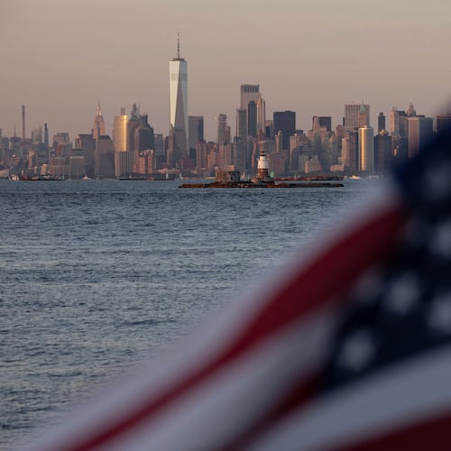 FILE - An American flag waves on Staten Island with the One World Trade Center in the distance, Sept. 11, 2024, in New York. (AP Photo/Yuki Iwamura, File)