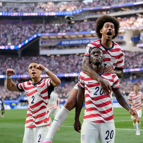 United States' Folarin Balogun (20) celebrates scoring his side's third goal against Paraguay with teamates during the World Cup Group D soccer match in Inglewood, Calif., near Los Angeles, Friday, June 12, 2026. (AP Photo/Andre Penner)