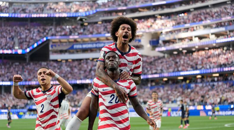 United States' Folarin Balogun (20) celebrates scoring his side's third goal against Paraguay with teamates during the World Cup Group D soccer match in Inglewood, Calif., near Los Angeles, Friday, June 12, 2026. (AP Photo/Andre Penner)