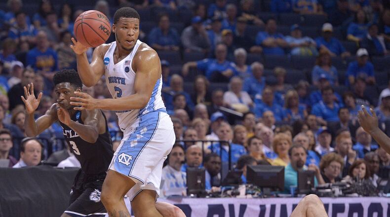 North Carolina forward Kennedy Meeks passes the ball against Butler forward Andrew Chrabascz and Butler guard Kamar Baldwin (3) in the first half of an NCAA college basketball tournament South Regional semifinal game Friday, March 24, 2017, in Memphis, Tenn. (AP Photo/Brandon Dill)