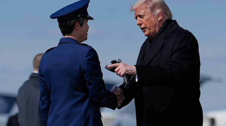 President Donald Trump greets Col. Matha "Jeannie" Sasnett, commander of Air Force Mortuary Affairs, as he arrives on Air Force One, Wednesday, March 18, 2026, at Dover Air Force Base, Del., to attend the casualty return for the six crew members of an Air Force refueling aircraft who died when their plane crashed in western Iraq while supporting operations against Iran. (AP Photo/Julia Demaree Nikhinson)
