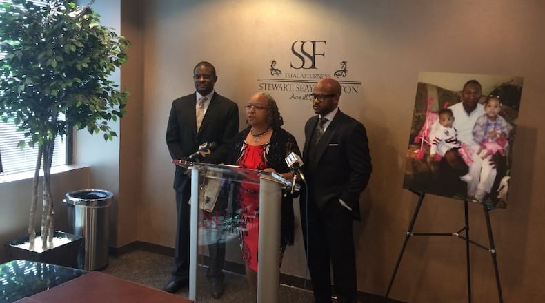 Gladys Mosley, center, discusses the lawsuit vs. Waffle House over her son’s death. STEVE BURNS/STEVE.BURNS@AJC.COM