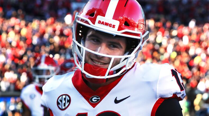 Georgia quarterback Stetson Bennett pumps his fist while celebrating a touchdown by running back Kenny McIntosh during the third quarter in a 45-0 shutout over Georgia Tech in NCAA college football game on Saturday, Nov. 27, 2021, in Atlanta.   “Curtis Compton / Curtis.Compton@ajc.com”`