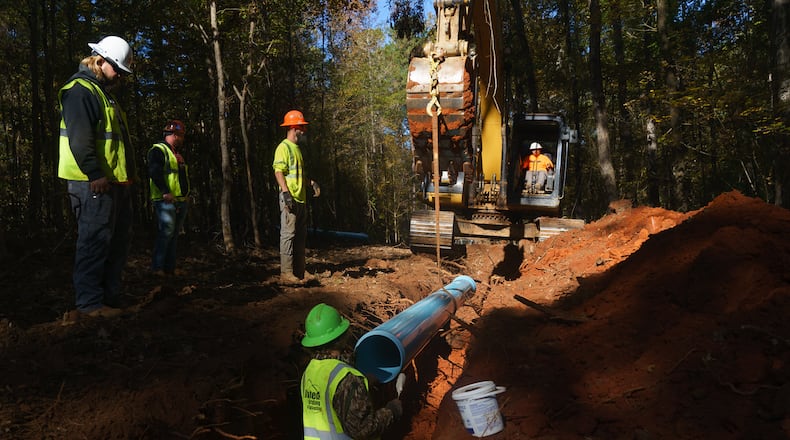 Contractors working for Monroe County lay water pipes, on Tuesday, November 9, 2021, near Juliette. (Elijah Nouvelage for The Atlanta Journal-Constitution)