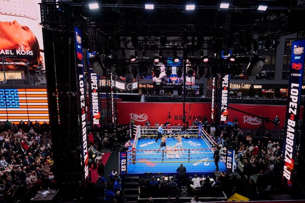 People gather in Times Square to watch a boxing match Friday, May 2, 2025, in New York. (AP Photo/Frank Franklin II)