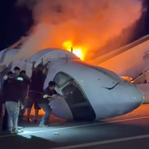 People attempt to pull passengers out of a plane after it crashed on a highway Tuesday, June 16, 2026, in Laredo, Texas. (Zayra Garza via AP)