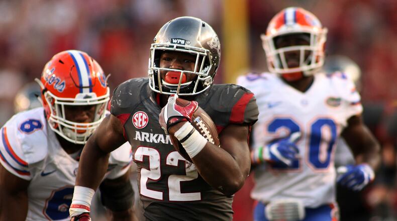 Arkansas' Rawleigh Williams III (22) outruns Florida's Nick Washington (8) and DeAndre Goolsby (30) during the second half of an NCAA college football game Saturday, Nov. 5, 2016 in Fayetteville, Ark. Arkansas beat Florida 31-10. (AP Photo/Samantha Baker)