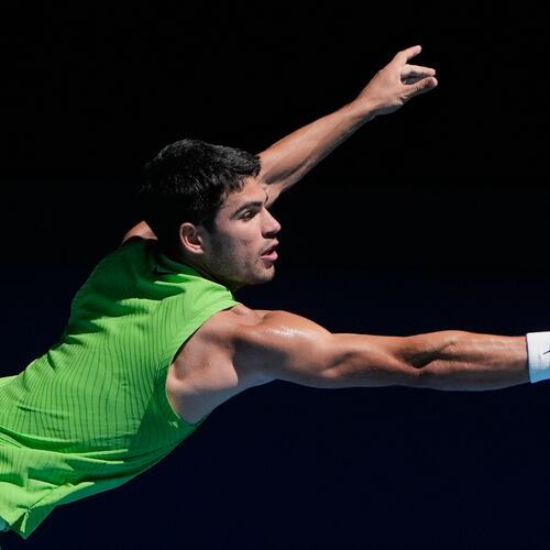 Carlos Alcaraz of Spain plays a backhand return to Corentin Moutet of France during their third round match at the Australian Open tennis championship in Melbourne, Australia, Friday, Jan. 23, 2026. (AP Photo/Asanka Brendon Ratnayake)