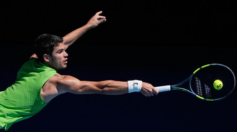 Carlos Alcaraz of Spain plays a backhand return to Corentin Moutet of France during their third round match at the Australian Open tennis championship in Melbourne, Australia, Friday, Jan. 23, 2026. (AP Photo/Asanka Brendon Ratnayake)