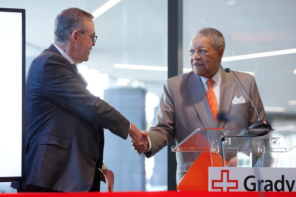 (Left to right) Grady Memorial Hospital CEO John Haupert shakes hands with Fulton Commission Chair Rob Pitts during the ribbon cutting ceremony for Correll Pavilion on Monday March 13, 2023. The 10-story wing will house outpatient surgeries and other non-emergency services at Grady. (Natrice Miller/ Natrice.miller@ajc.com)