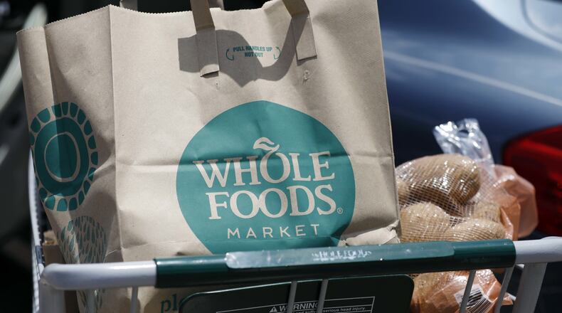 Groceries sit in a cart outside a Whole Foods store in an AP file photo.