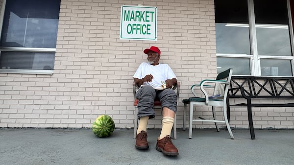 Gate monitor Johnny C. Daniels oversees an entrance at the Cordele State Farmers Market. (Joe Kovac Jr./AJC)