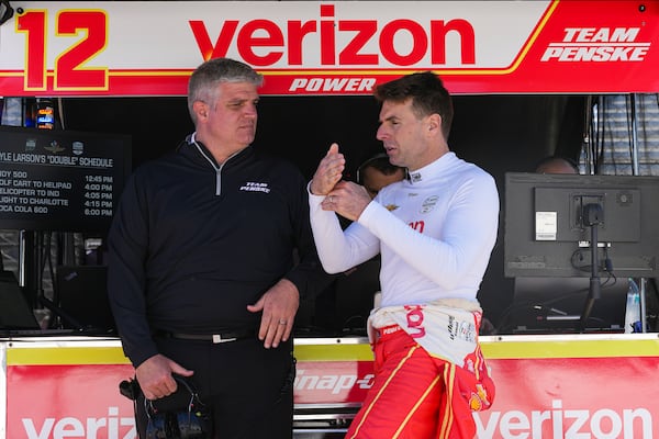 Will Power, of Australia, right, talks with strategist Jonathan Diuguid before the start practice for the Indianapolis 500 auto race at Indianapolis Motor Speedway in Indianapolis, Friday, May 23, 2025. (AP Photo/Michael Conroy)