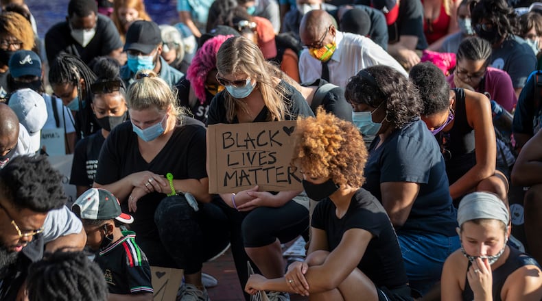 Demonstrators with the Public Defenders for Black Lives rally kneel as they take a moment of silence near the crypt of Martin Luther King Jr. and Coretta Scott King following their rally at Ebenezer Baptist Church during the 11th day of protests in Atlanta. The demonstrators were silent for 8 minutes, to honor the life of George Floyd. (Photo: Alyssa Pointer/AJC)