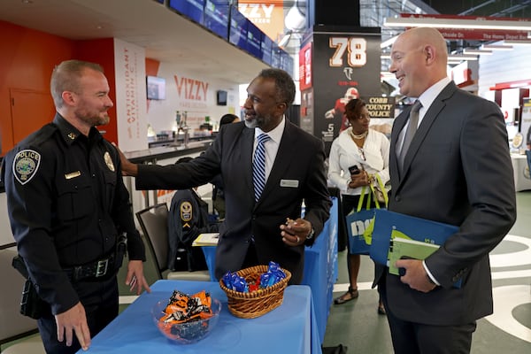Mableton city manager Bill Tanks (center) speaks with law enforcement officers during a Veterans Job Fair at Mercedes-Benz Stadium in 2022. (Jason Getz/AJC)