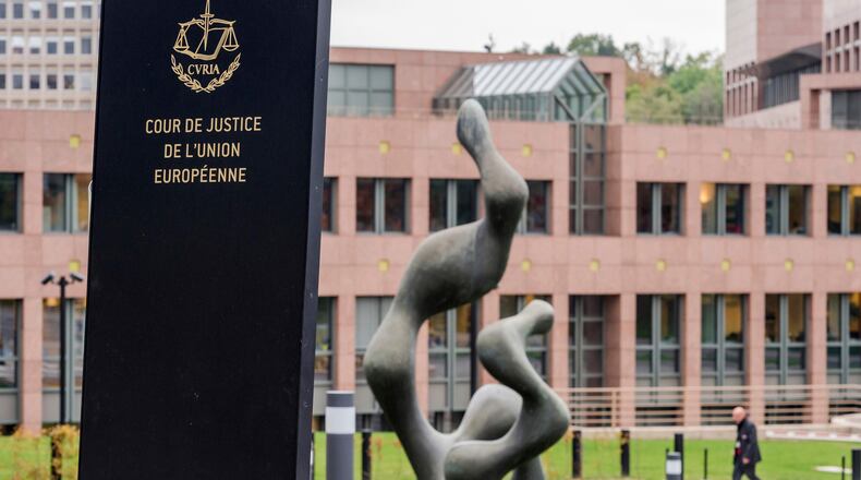 FILE - A man walks by the European Court of Justice in Luxembourg, Oct. 5, 2015. (AP Photo/Geert Vanden Wijngaert, File)