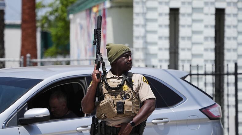 A sheriff's deputy stages at the scene of a shooting outside the Islamic Center of San Diego Monday, May 18, 2026, in San Diego. (AP Photo/Gregory Bull)
