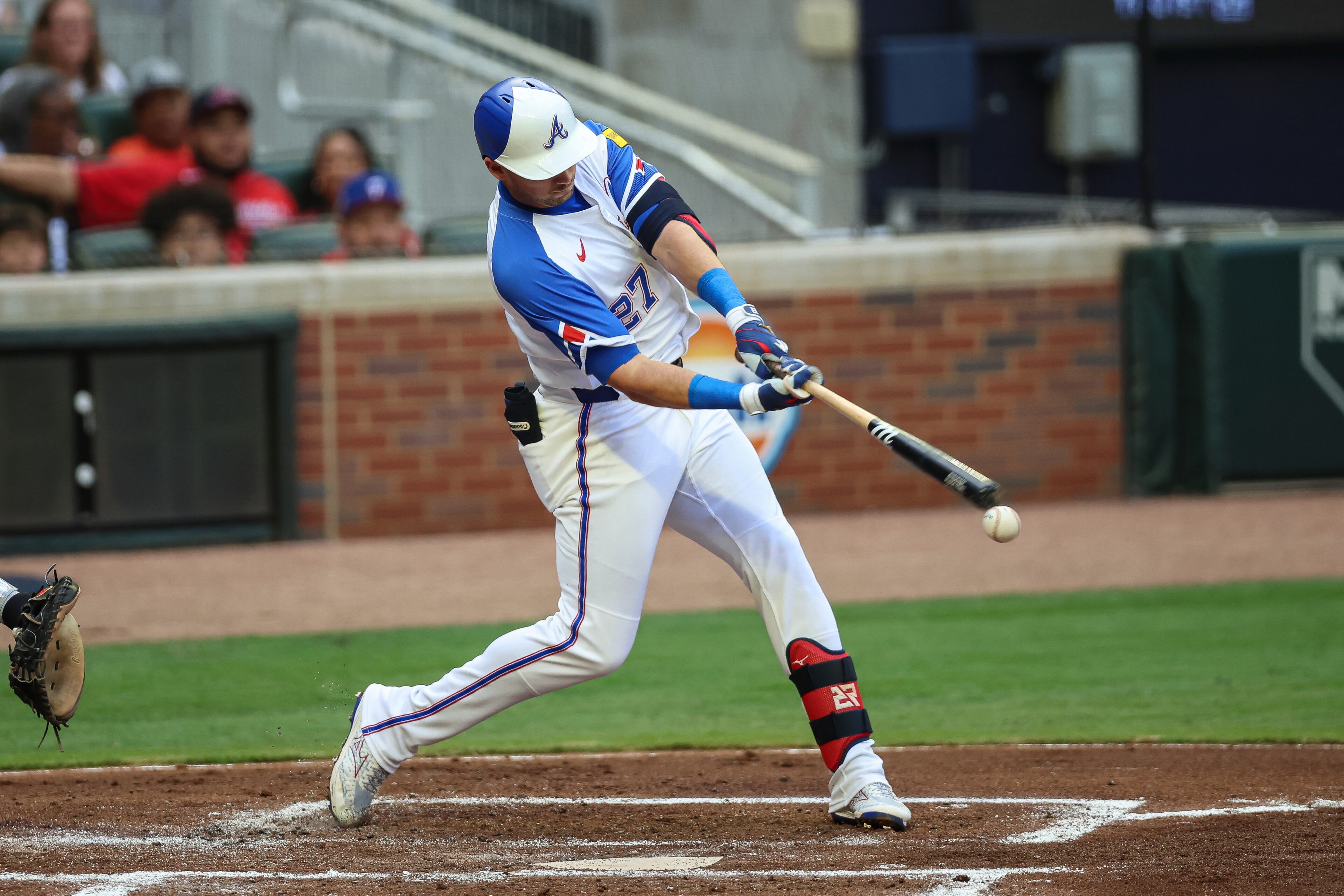 Atlanta Braves' Austin Riley (27) hits an RBI single in the first inning of a baseball game against the Philadelphia Phillies, Saturday, June 28, 2025, in Atlanta. (AP Photo/Colin Hubbard)