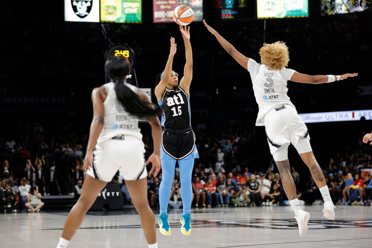 Atlanta Dream guard Allisha Gray shoots between Las Vegas Aces guard Jackie Young (left) and forward NaLyssa Smith during the first half of their Aug. 18 game in in Las Vegas. (Steve Marcus/Las Vegas Sun via AP)