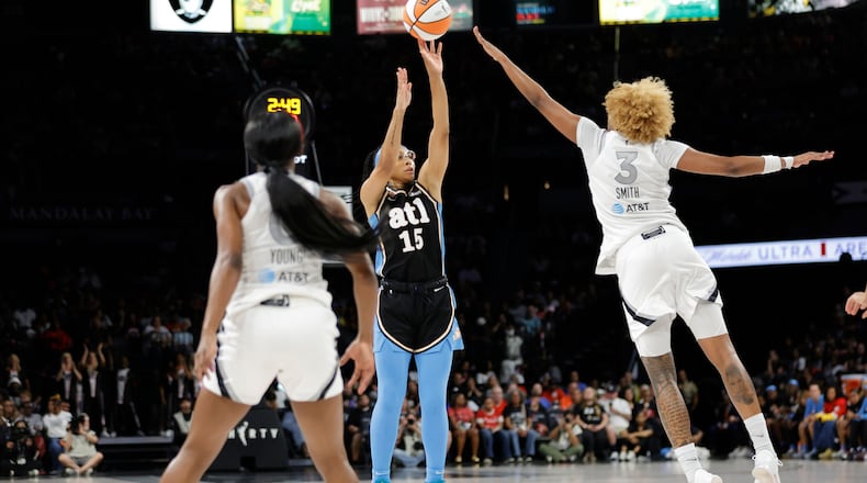 Atlanta Dream guard Allisha Gray shoots between Las Vegas Aces guard Jackie Young (left) and forward NaLyssa Smith during the first half of their Aug. 18 game in in Las Vegas. (Steve Marcus/Las Vegas Sun via AP)