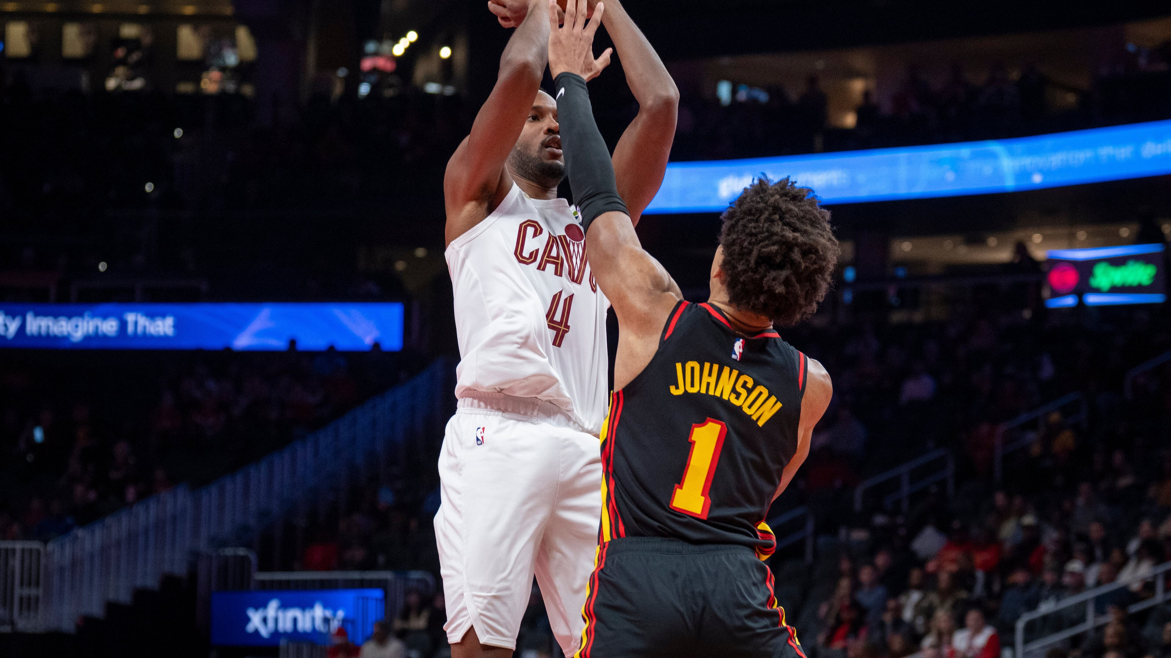 Cleveland Cavaliers center Evan Mobley (4), left, attempts a basket against Atlanta Hawks forward Jalen Johnson (1), right, during the first half of an NBA Cup basketball game, Friday, Nov. 28, 2025, in Atlanta. (AP Photo/Erik Rank)