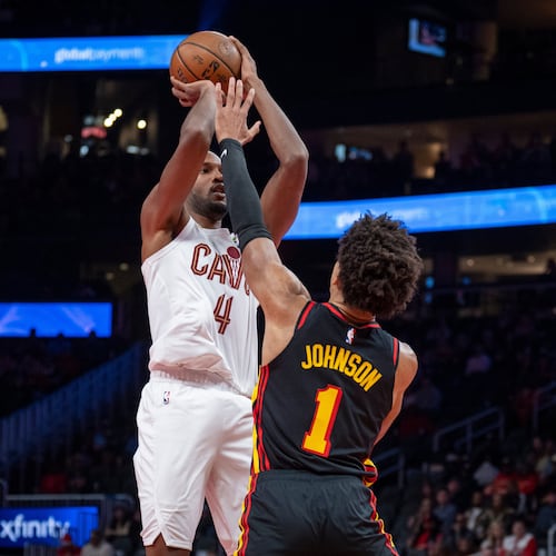 Cleveland Cavaliers center Evan Mobley (4), left, attempts a basket against Atlanta Hawks forward Jalen Johnson (1), right, during the first half of an NBA Cup basketball game, Friday, Nov. 28, 2025, in Atlanta. (AP Photo/Erik Rank)