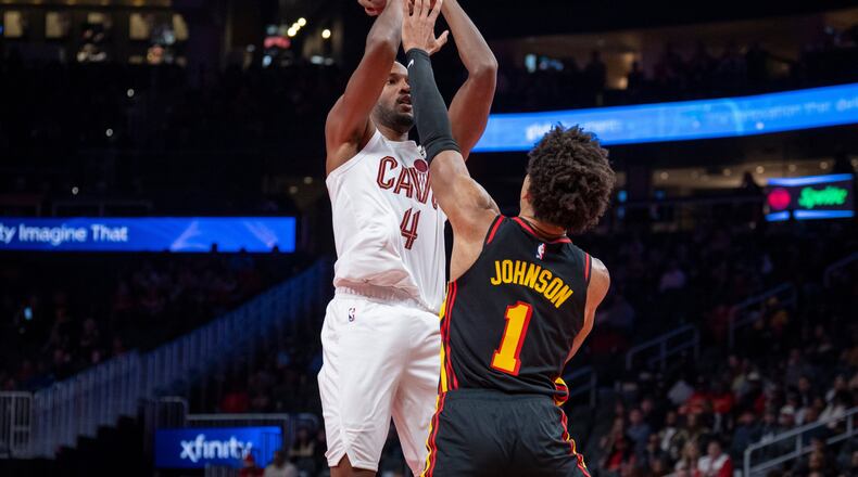 Cleveland Cavaliers center Evan Mobley (4), left, attempts a basket against Atlanta Hawks forward Jalen Johnson (1), right, during the first half of an NBA Cup basketball game, Friday, Nov. 28, 2025, in Atlanta. (AP Photo/Erik Rank)