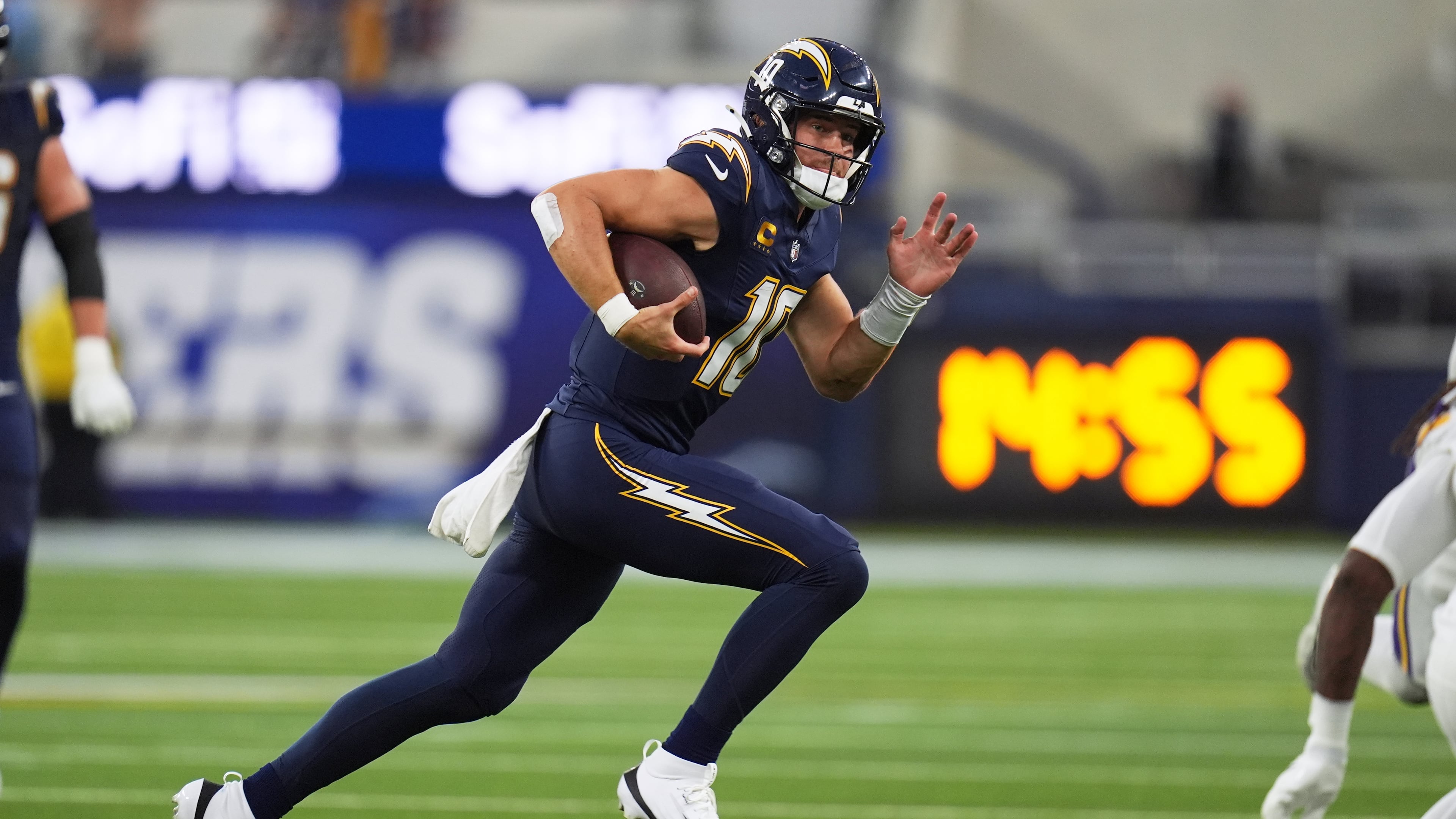 Los Angeles Chargers quarterback Justin Herbert (10) runs with the football during the first half of an NFL football game against the Minnesota Vikings Thursday, Oct. 23, 2025, in Inglewood, Calif. (AP Photo/Gregory Bull)