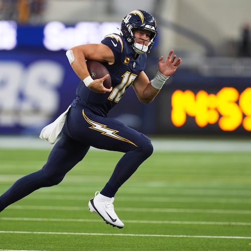 Los Angeles Chargers quarterback Justin Herbert (10) runs with the football during the first half of an NFL football game against the Minnesota Vikings Thursday, Oct. 23, 2025, in Inglewood, Calif. (AP Photo/Gregory Bull)