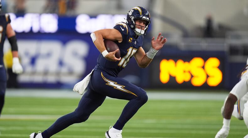 Los Angeles Chargers quarterback Justin Herbert (10) runs with the football during the first half of an NFL football game against the Minnesota Vikings Thursday, Oct. 23, 2025, in Inglewood, Calif. (AP Photo/Gregory Bull)