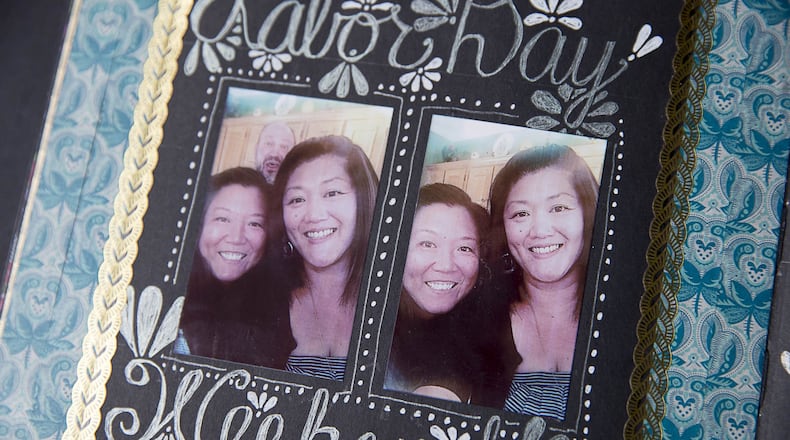 A scrapbook commemorating the newly created relationship between sisters Janine Dzyubanny and Jennifer Franz is displayed on a coffee table at Janine’s residence in Johns Creek. ALYSSA POINTER / ALYSSA.POINTER@AJC.COM