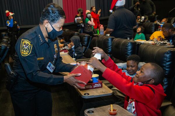 Dekalb County Police Chief Mirtha Ramos hands Josiah Owens a napkin as the Police Athletic League (PAL) hosted a "Movie with a cop" event at the Movie Tavern in Tucker in the 2021 file photo. PHIL SKINNER FOR THE ATLANTA JOURNAL-CONSTITUTION.