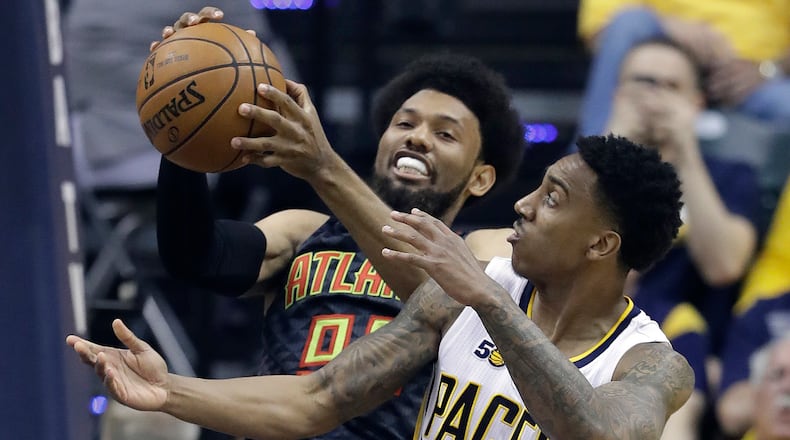 Atlanta Hawks’ DeAndre’ Bembry and Indiana Pacers’ Jeff Teague vie for a rebound during the first half of an NBA basketball game Wednesday, April 12, 2017, in Indianapolis. (AP Photo/Darron Cummings)