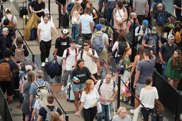 Travelers queue up to pass through the south security checkpoint in Denver International Airport Wednesday, July 2, 2025, in Denver. (AP Photo/David Zalubowski)