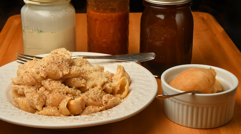 Reduce food waste and free up fridge space with recipes that call for ingredients you already have on hand. (From left to right in jars) ranch dressing, chipotle-honey vinaigrette, olive brine vinaigrette. (Front row) Miso-Cream Cheese Pasta (left) and Applesauce Sorbet (right) (Styling by C. W. Cameron / Chris Hunt for The Atlanta Journal-Constitution)