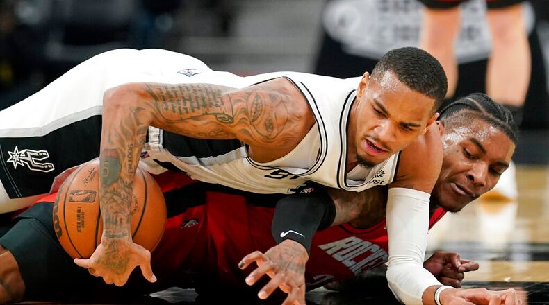 Former Spurs guard Dejounte Murray, top, will look to make life easier for Hawks guard Trae Young beginning this season after Atlanta acquired Murray in a trade. (AP Photo/Eric Gay)