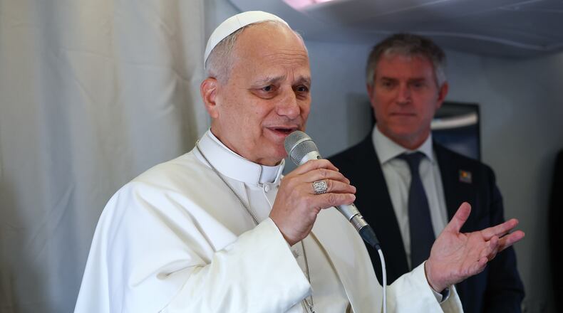 Pope Leo XIV speaks to journalists aboard his flight bound for Yaounde-Nsimalen International Airport, Cameroon, Wednesday, April 15, 2026, on the third day of an 11-day apostolic journey to Africa. (Guglielmo Mangiapane/Pool Photo via AP)