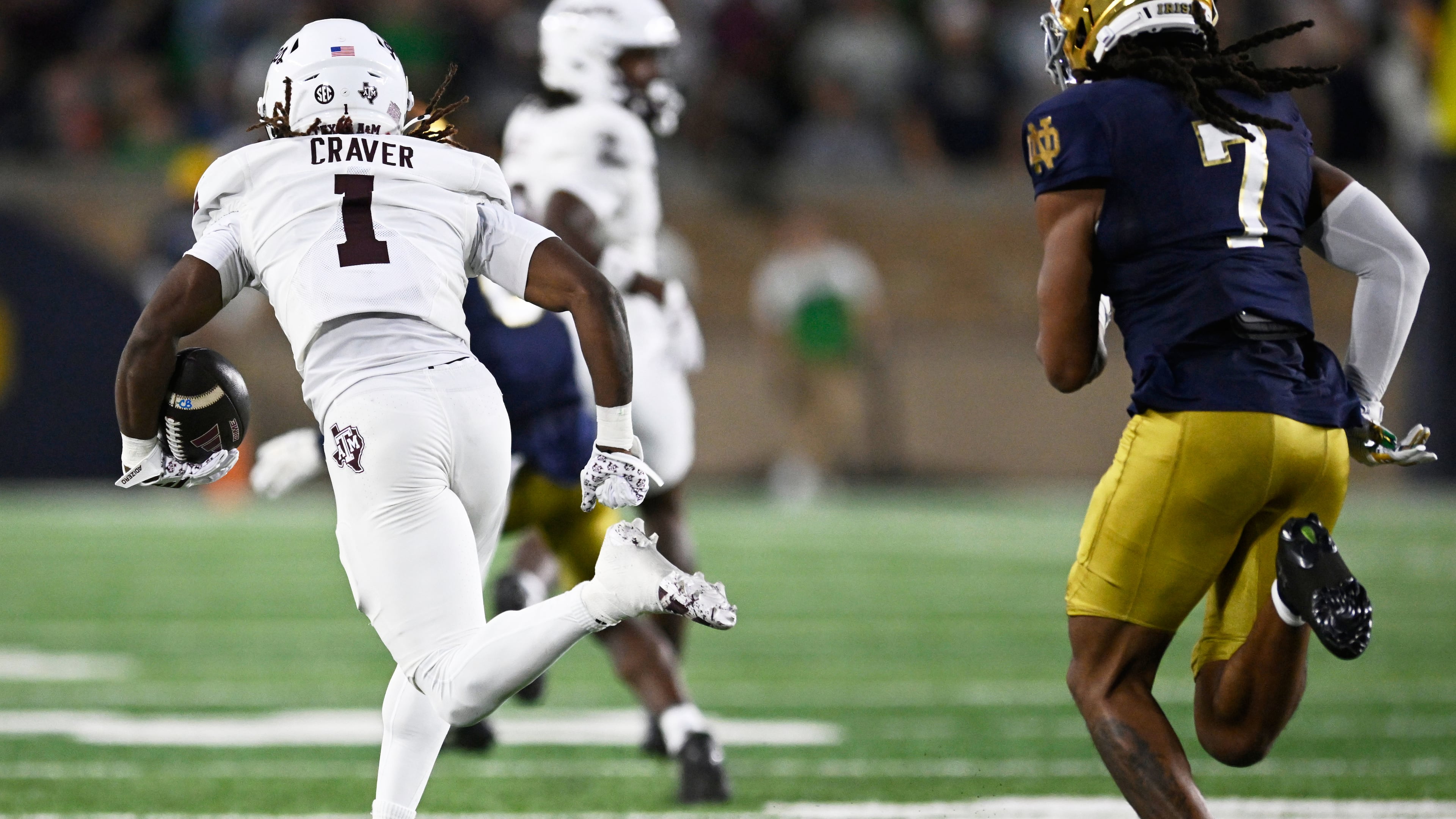 Texas A&M wide receiver Mario Craver (1) rushes for a 86 yard touchdown after catching a pass against Notre Dame's Ty Washington (7) during the first half of an NCAA football game Saturday, Sept. 13, 2025, in South Bend, Ind. (AP Photo/Paul Beaty)