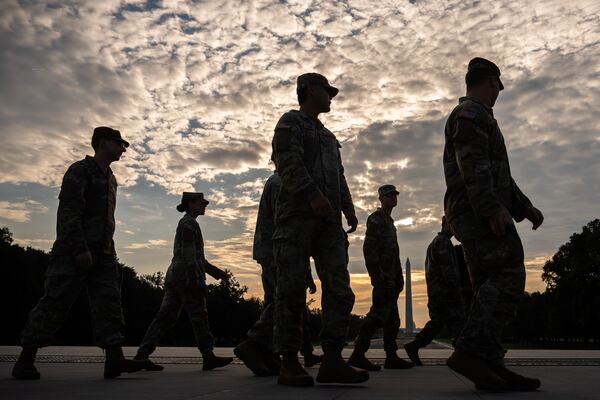 Members of the National Guard walk past the Lincoln Memorial Reflecting Pool before the March on Washington last month. (Julia Demaree Nikhinson/AP)