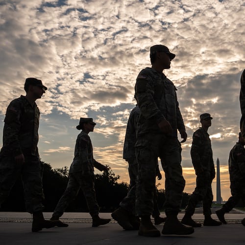 Members of the National Guard walk past the Lincoln Memorial Reflecting Pool before the March on Washington, Friday, Aug. 28, 2026, in Washington. (AP Photo/Julia Demaree Nikhinson)
