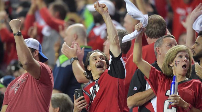 Falcons fans celebrate in the second half during the NFC divisional playoffs at the Georgia Dome on Saturday, January 14, 2017. Atlanta Falcons won 36-20 over the Seattle Seahawks. HYOSUB SHIN / HSHIN@AJC.COM