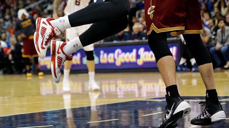Atlanta Hawks' Mike Scott, left, puts up a shot against Cleveland Cavaliers' Spencer Hawes in the second quarter of an NBA basketball game, Friday, April 4, 2014, in Atlanta. The Hawks beat the Cavaliers 117-98. (AP Photo/David Goldman)