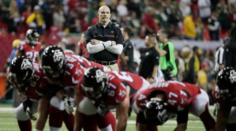 Atlanta Falcons head coach Dan Quinn watches warm ups before the NFC championship game against the Green Bay Packers Sunday, Jan. 22, 2017, in Atlanta.