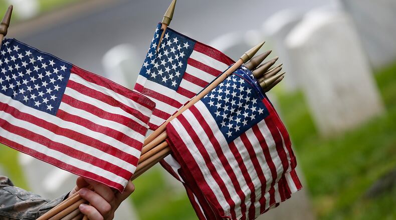 ARLINGTON, VA - MAY 21: Members of the 3rd U.S. Infantry Regiment place American flags at the graves of U.S. soldiers buried at Arlington National Cemetery, in preparation for Memorial Day May 21, 2015 in Arlington, Virginia. 'Flags-In' has become an annual ceremony since the 3rd U.S. Infantry Regiment (The Old Guard) was designated to be an Army's official ceremonial unit in 1948 (Photo by Win McNamee/Getty Images)